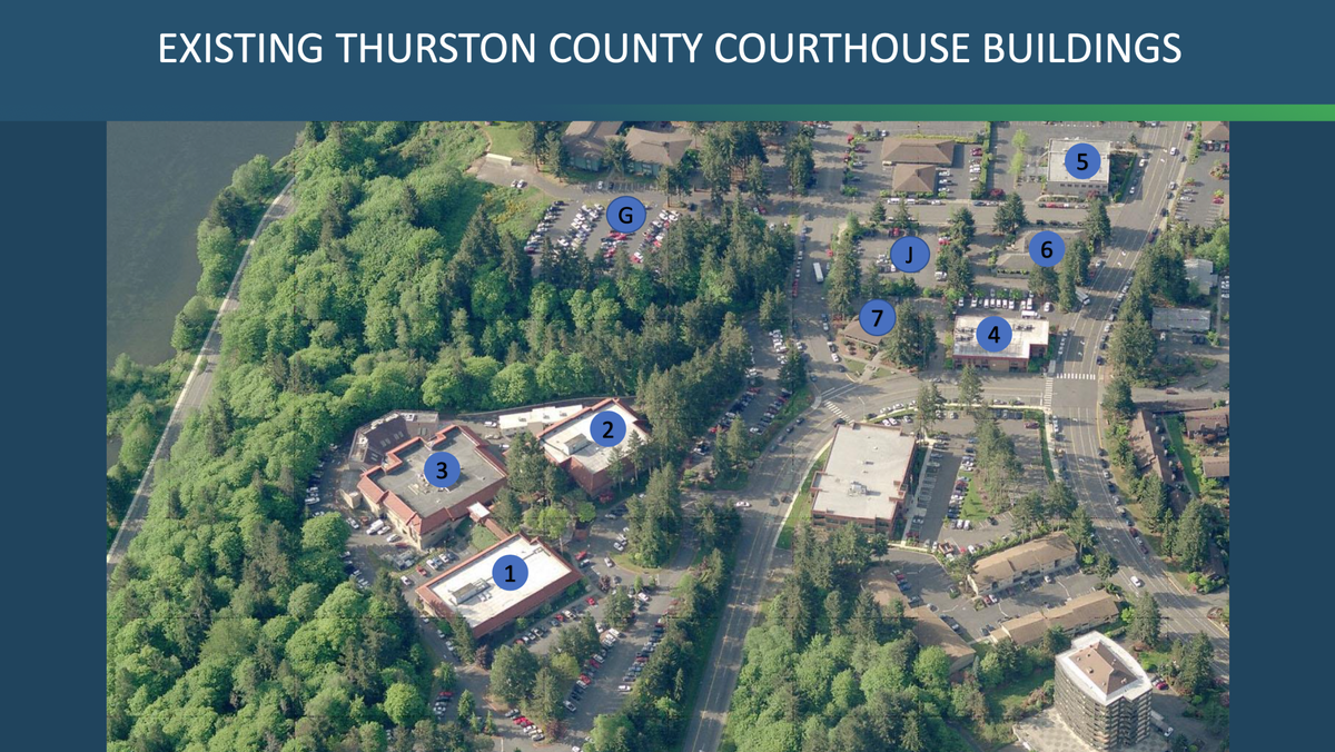 An aerial view of the existing Thurston County Courthouse buildings at Lakeridge Drive in Olympia. The buildings are numbered and the parking lots are lettered.