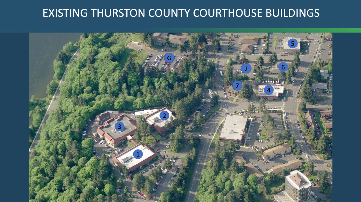 An aerial view of the existing Thurston County Courthouse buildings at Lakeridge Drive in Olympia. The buildings are numbered and the parking lots are lettered.