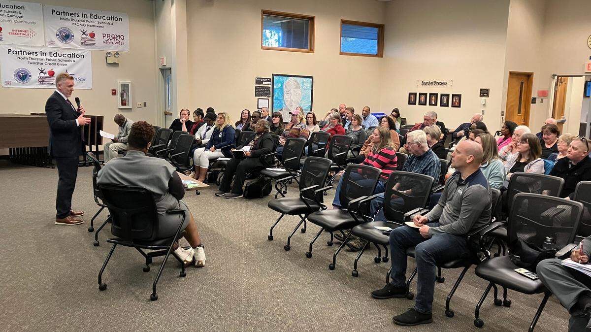 Justin Ainsworth (far left), who addressed a North Thurston Public Schools gathering before he was offered the job of superintendent on April 10, resigned from that position on Tuesday.