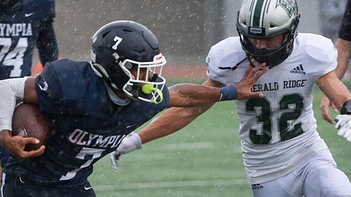 Olympia running back Kenyatta Mcneese stiff arms Emerald Ridge linebacker Rob Rhyner. Emerald Ridge hung on to defeat the Olympia Bears, 28-26, at Ingersoll Stadium in Olympia on Saturday, Sept. 18, 2021.