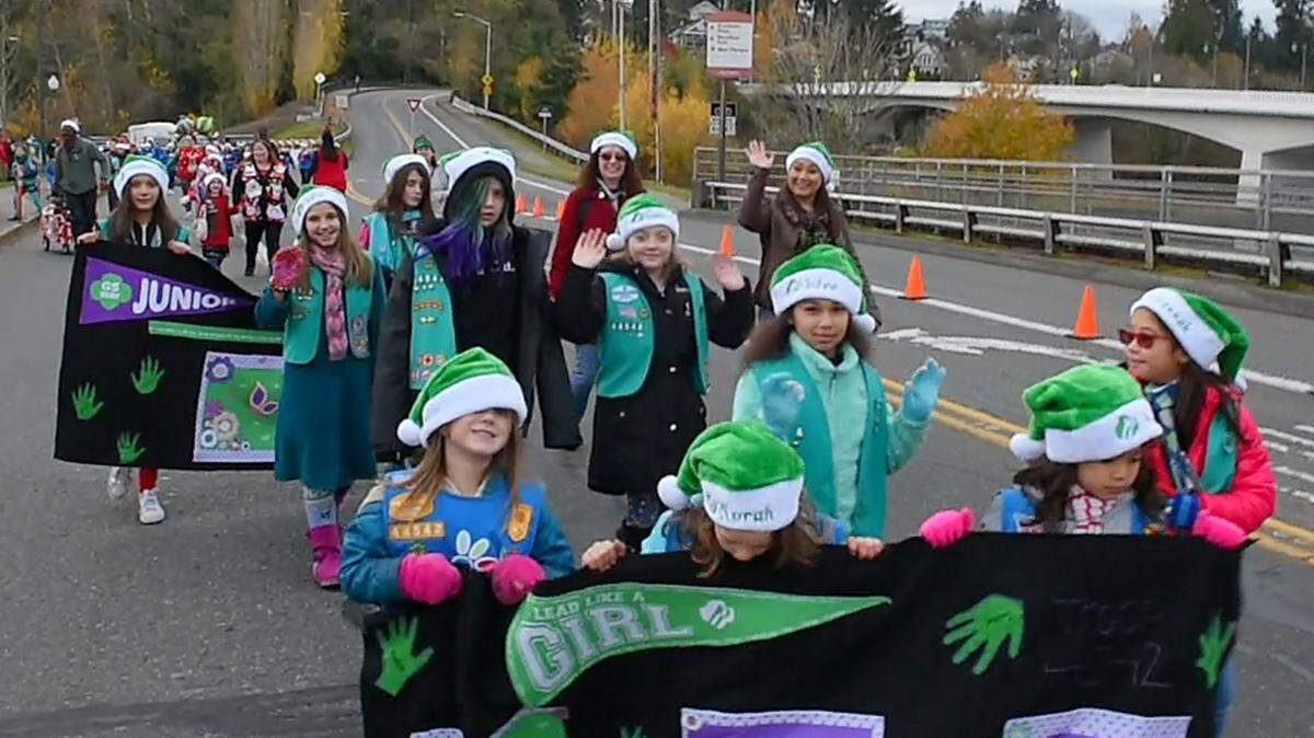 A contingent of Girl Scouts moves along Fifth Avenue as the 2018 Jingle Bell Parade follows a new route from Deschutes Parkway to Sylvester Park as part of the annual “Downtown for the Holidays” celebration. The parade will start at 1 p.m. Sunday.