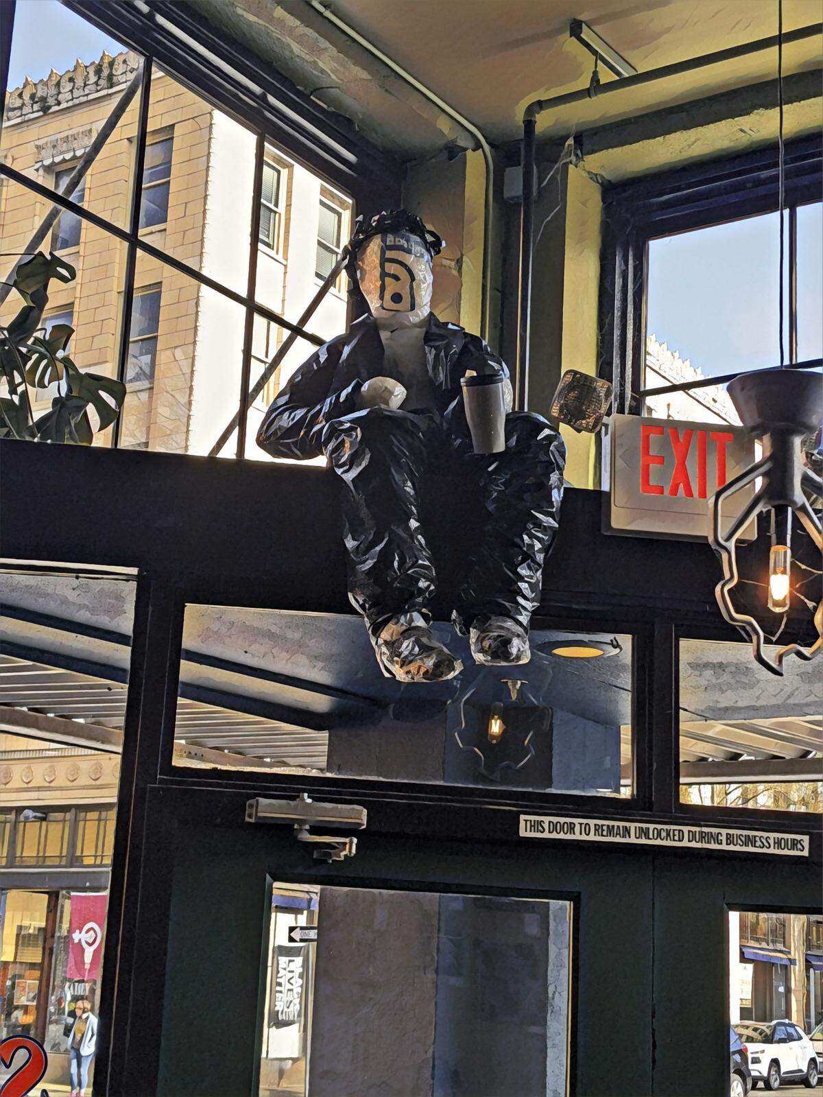This coffee drinker made largely of plastic bags is among the pieces Ruby Re-Usable is showing at Schwarz’s during Arts Walk. Actor Tom Sanders was the model.