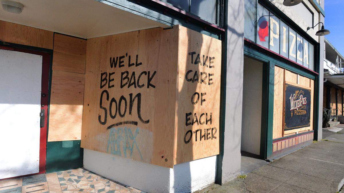 A message of hope was left on the plywood siding covering the shuttered Wicked Pies restaurant along Olympia’s Franklin Street.