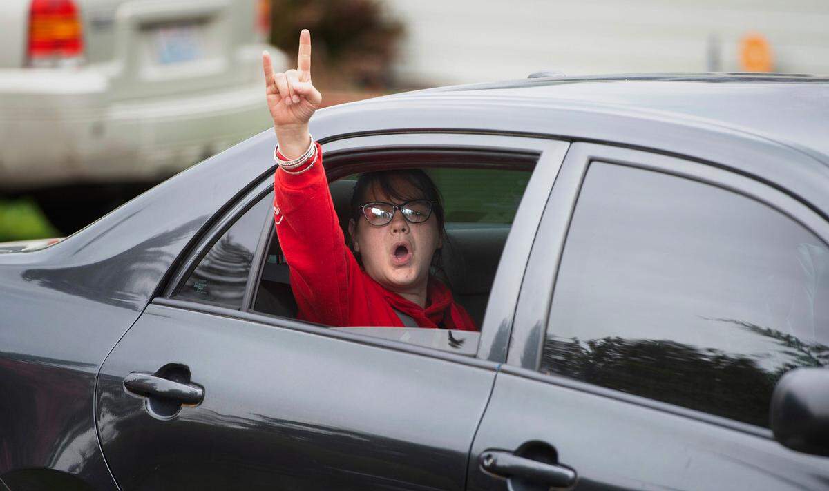 A passerby offers support to Hicks Lake neighbors as they protest the proposed apartment complex in their neighborhood along Ruddell Road in Lacey, Washington, on Friday, May 13, 2022.