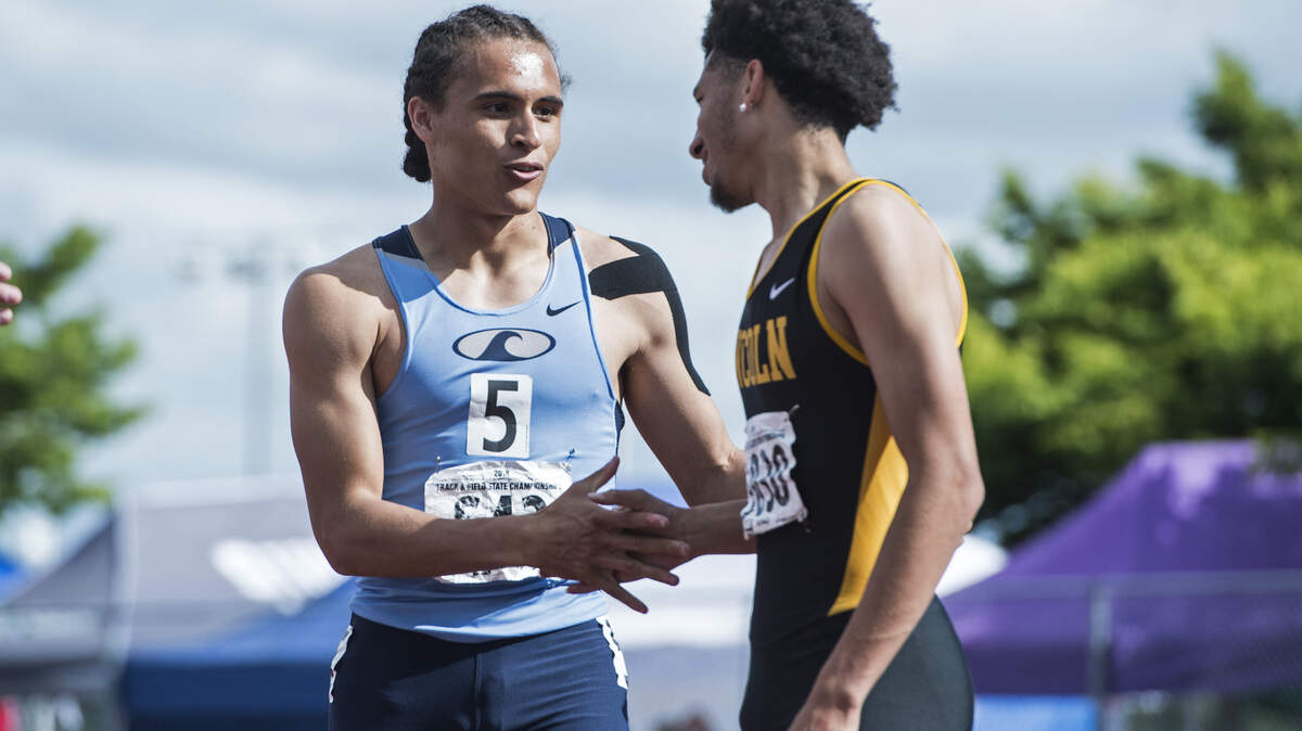 Jurrian Hering of Gig Harbor shakes hands with Lincoln’s Marcus William’s Jr. following the 3A boys 110-meter hurdles finals at the 4A/3A/2A track and field state championships at Mount Tahoma High School in Tacoma on Friday, May 25, 2018.