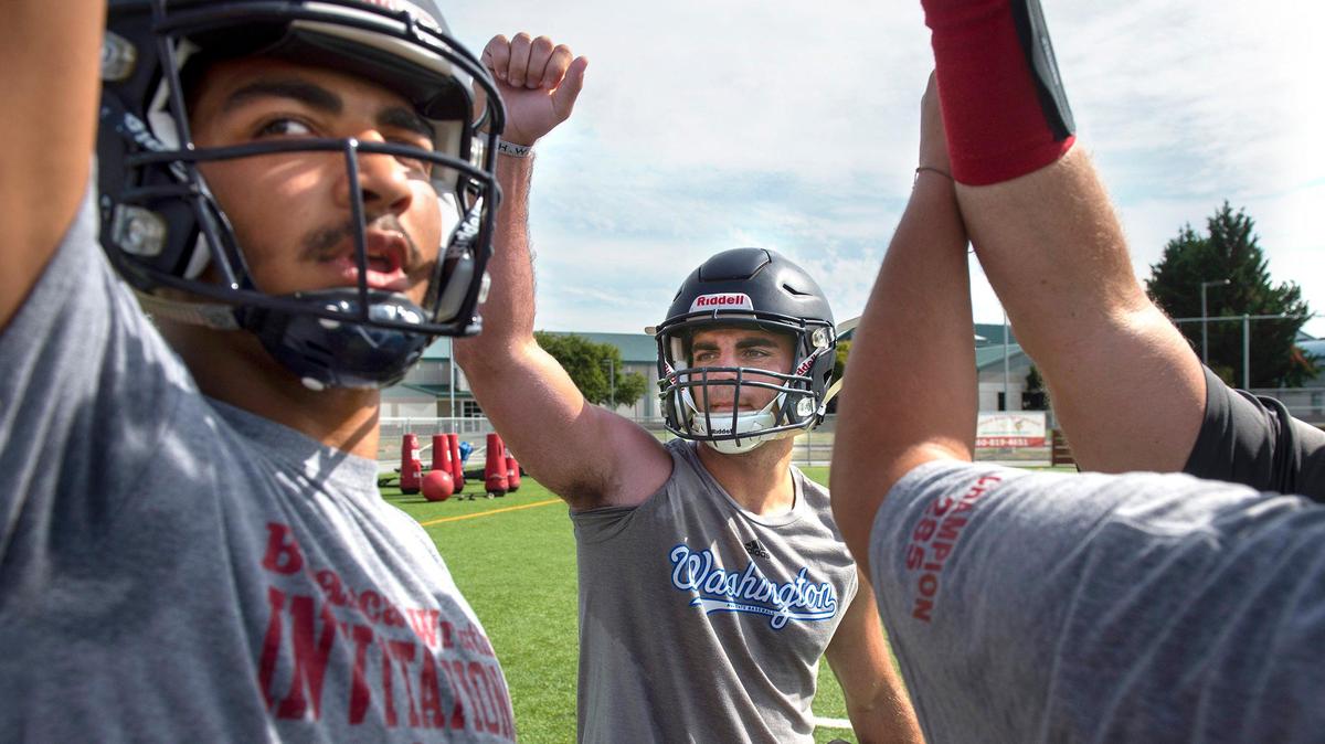 Black Hills seniors Julian Kennedy (left) and Zach Loveless fire up the Wolves during football practice at Black Hills High School in Tumwater on Friday, Aug. 23, 2019.