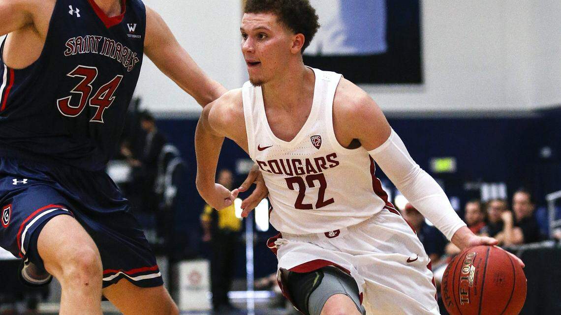 Washington State guard Malachi Flynn, right, dribbles against Saint Mary's center Jock Landale during the second half of an NCAA college basketball game at the Wooden Legacy tournament Friday, Nov. 24, 2017, in Fullerton, Calif. Washington State won 84-79.