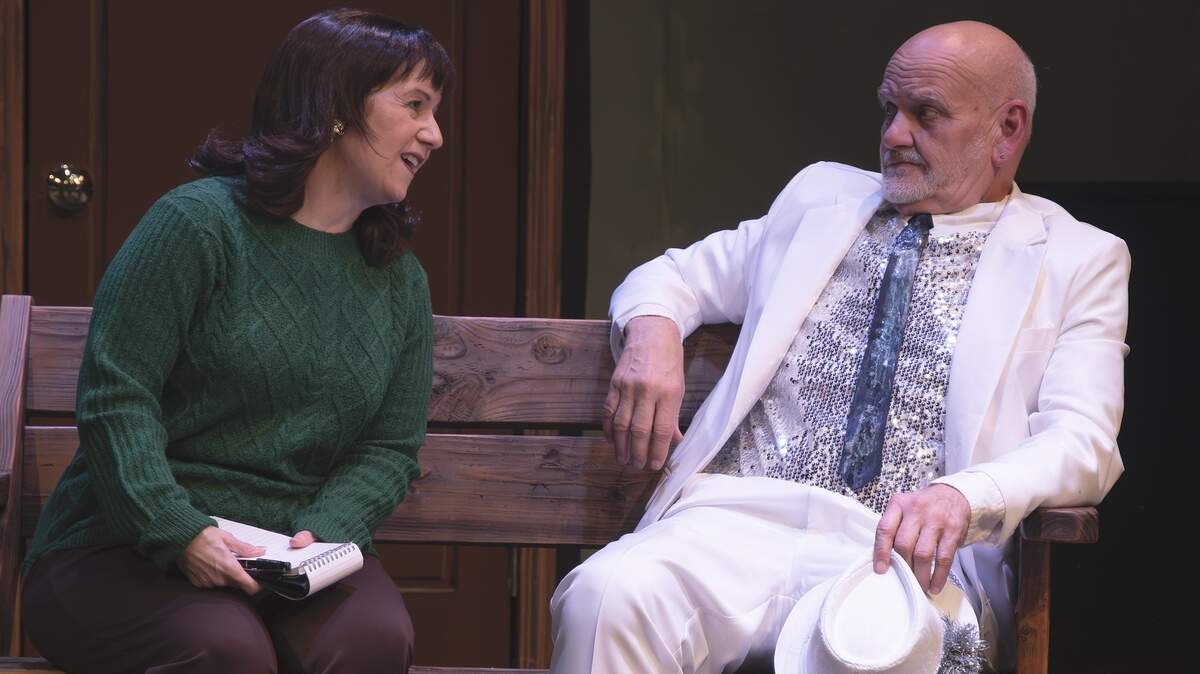 Reporter Penelope (Jean Kivi-Thomas) has some questions for Leo Tannenbaum (Chuck Meares), a mysterious stranger who comes to town on Christmas Eve in Olympia Little Theater’s “The Christmas Express.”
