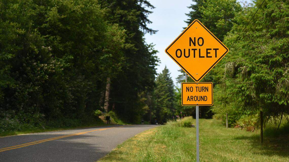Yellow No Outlet sign above a No turn around sign along Cooper Point road.