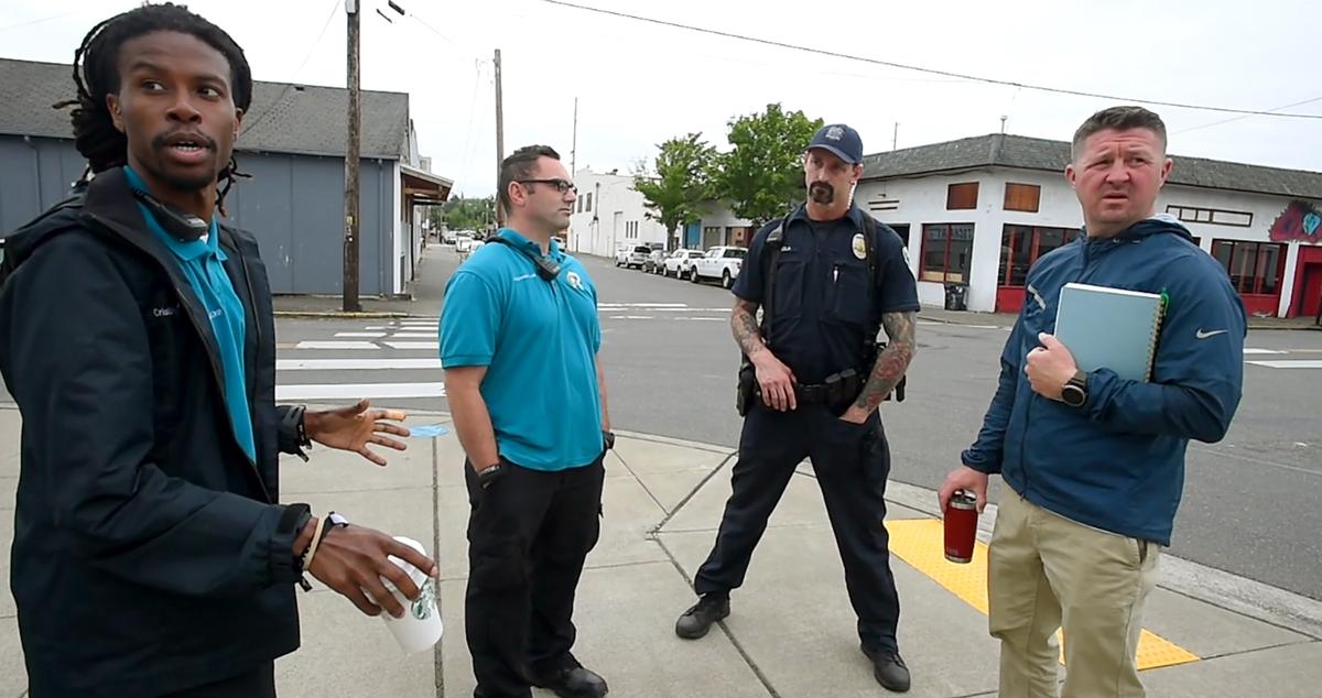 Christopher Jones, from left, and David Gervais of CRU talk with Olympia Police Officer Javier Sola Del Vigo and Colin DeForrest, Olympia’s homeless response coordinator, about people they’ve encountered that day.