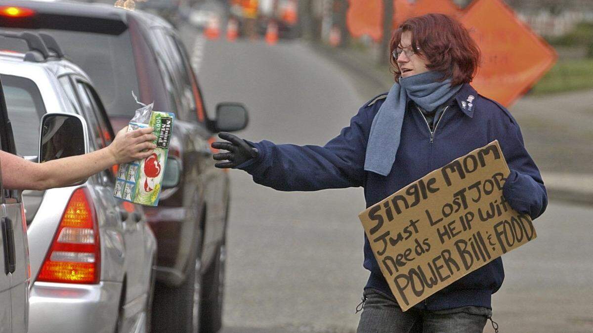 METRO SHERMAN STORY Kari (who declines to give a last name) is given cartons of juice by a motorist at the freeway exit at S. 19th st. and S. Sprague Ave. Her sign says that she is a single mother. by Peter Haley Jan 23, 2007