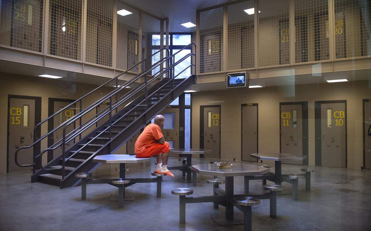 An inmate watches television in the common area of a maximum custody/special needs unit at the Thurston County Corrections Facility in Tumwater on Thursday, Sept. 12, 2019.