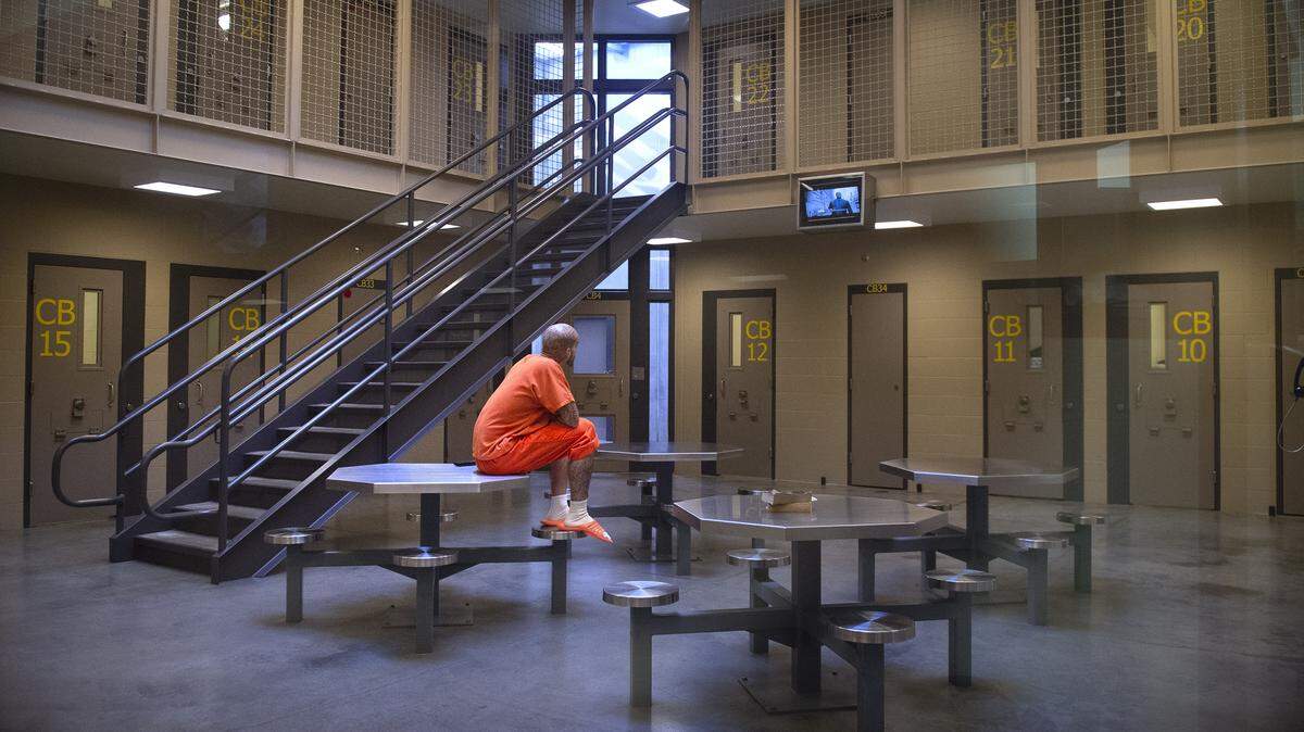 An inmate watches television in the common area of the maximum custody/security needs cellblock at the Thurston County Accountability & Restitution Center in Tumwater on Thursday.
