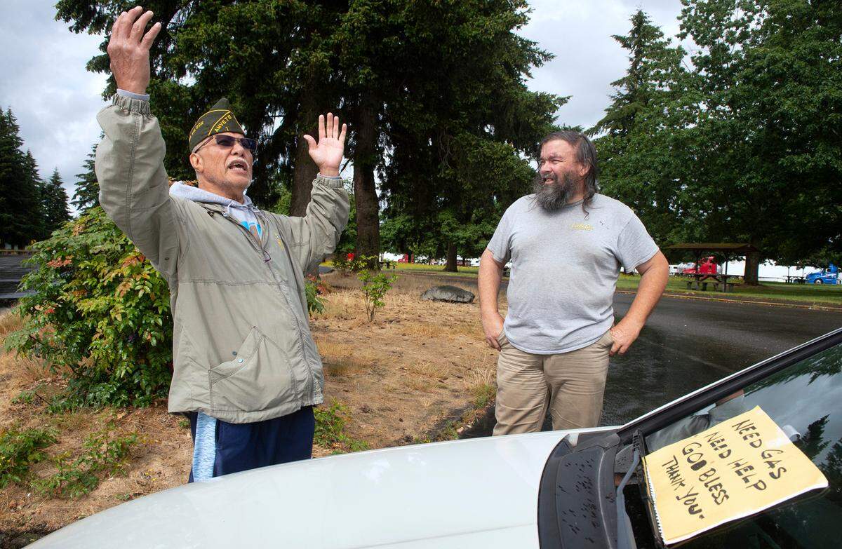 Army veteran Puletua Wilson shares stories of living in his car with friend Arnold Hampton as they meet up at the Scatter Creek Rest Area along Interstate 5 south of Olympia on July 7. Wilson, who has been homeless for three months, said he splits his time between various rest areas so as to not draw attention to himself.