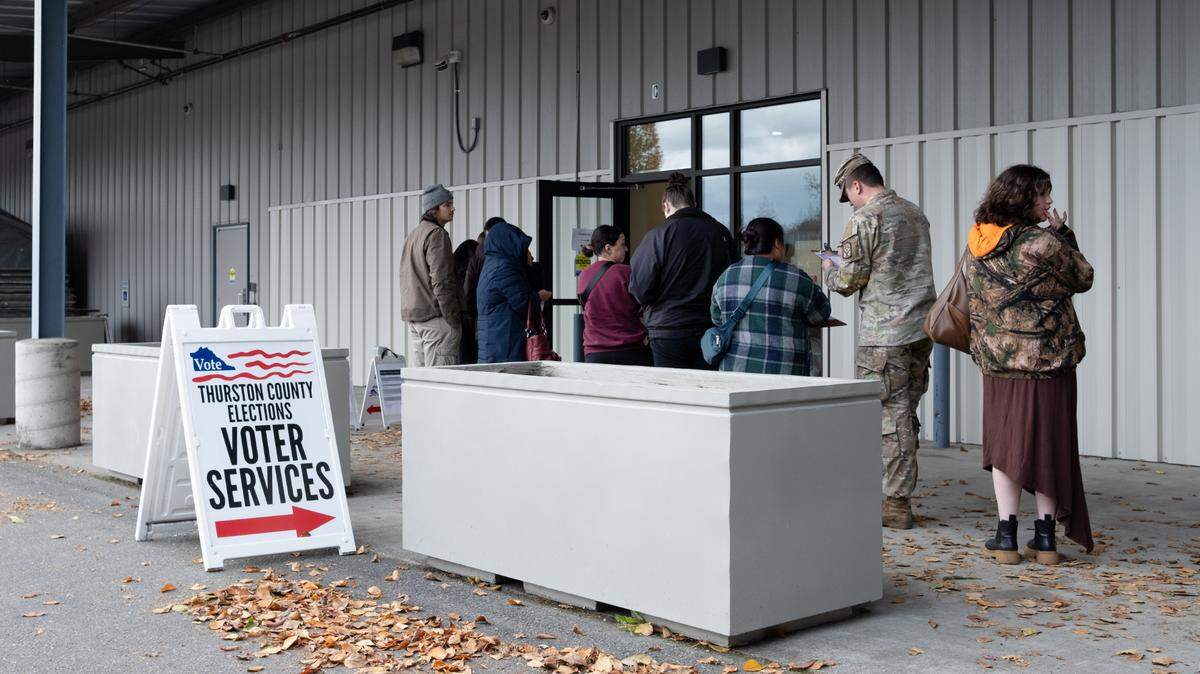 About two dozen voters lined up along the outer wall of Thurston County’s primary voting center in the Tumwater Mottman neighborhood for the November general election.