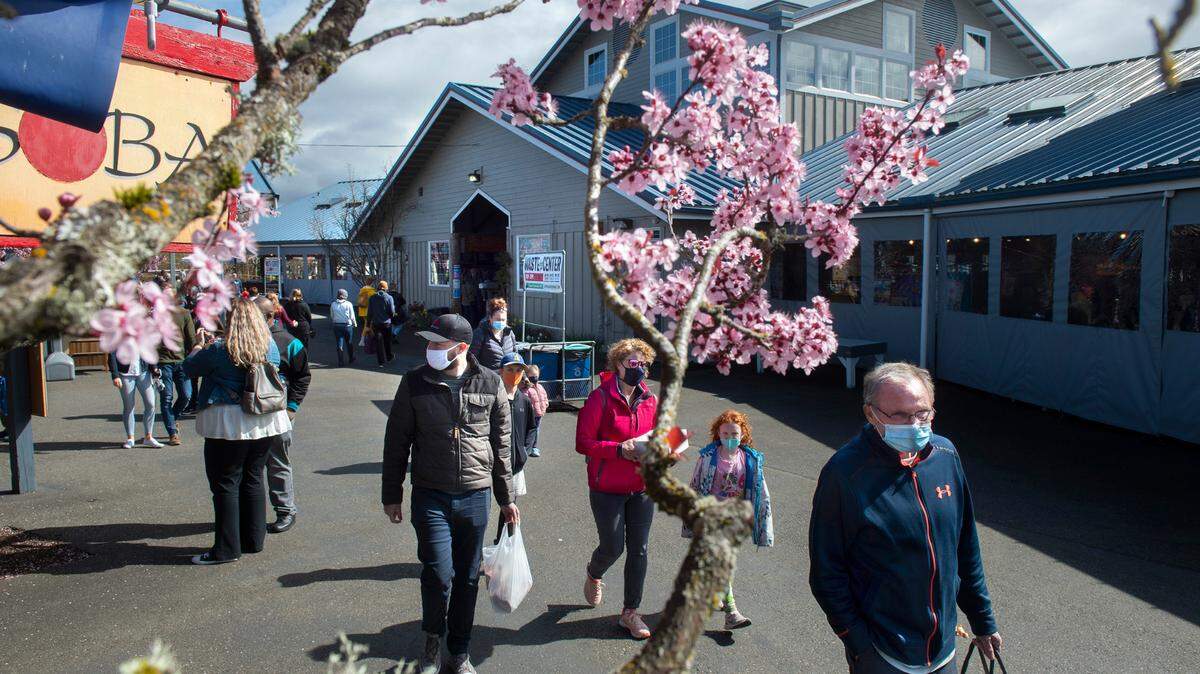 Customers move through the Olympia Farmers Market in Olympia, Washington on Saturday, March 20, 2021.