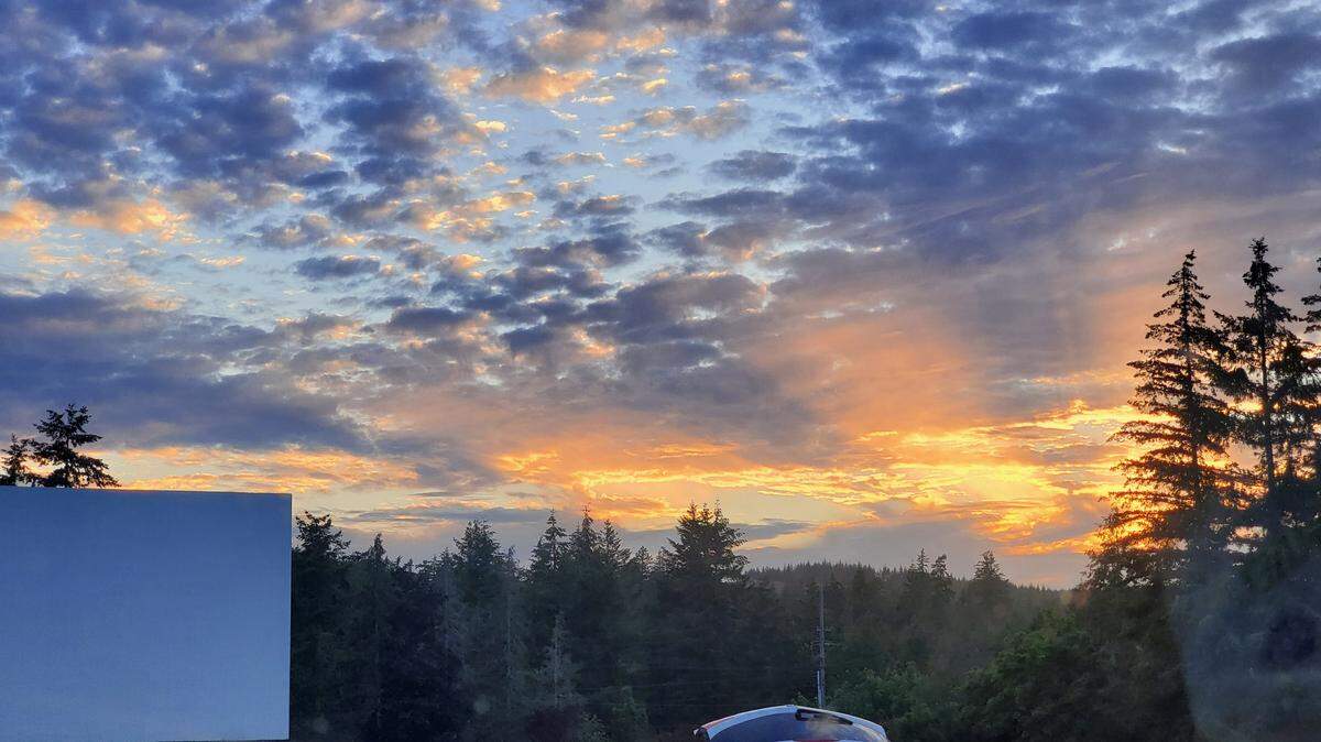 A beautiful sunset over Shelton’s Skyline Drive-In movie theater on opening night..