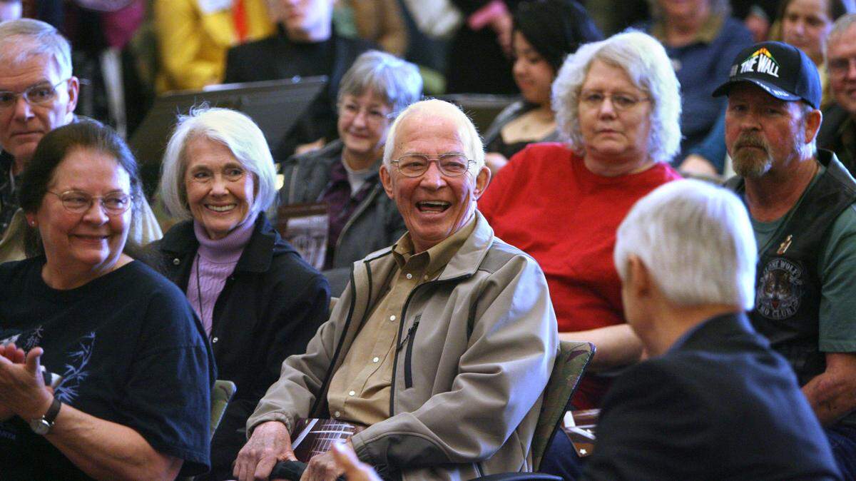 Former Olympia City Council member Gil Carbone is greeted by friends during the dedication ceremonies for the new Olympia City Hall in 2011.