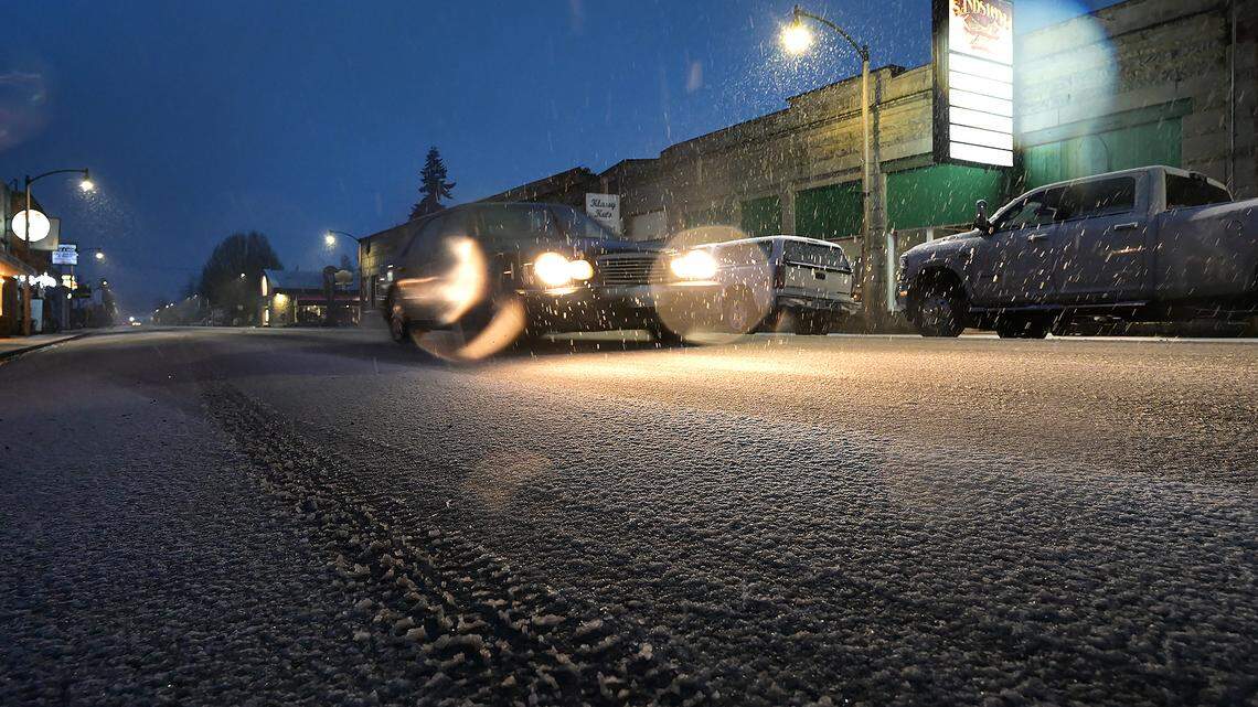 A wet snow covers Sussex Avenue in Tenino just before sunrise on Sunday, Feb. 26.