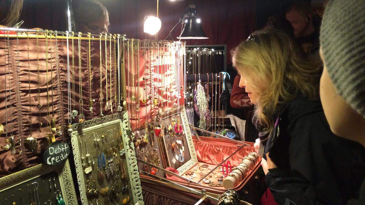 Customers get a good look at jewelry for sale at Duck the Malls. The 17th annual crafts extravaganza is set for Dec. 14 and will feature more than 60 artisans.