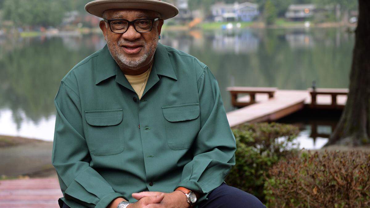 Merritt Long sits outside his home at Ken Lake in Olympia. Long has written a memoir called “My View from the Back of the Bus” that chronicles growing up in the segregated South amid Jim Crow laws, attending Morehouse College in Atlanta, and moving to the Pacific Northwest where he became the head of several state agencies.