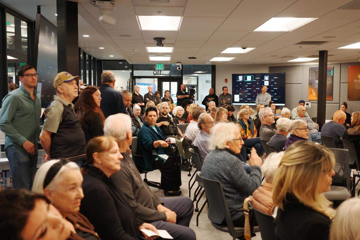 Thurston County Sheriff Derek Sanders sits in a crowded room during a Board of County Commissioners meeting at The Atrium on Tuesday, Sept. 30, 2025. Sanders invited the public to speak out against proposed budget cuts at the meeting in a Sunday Facebook post.