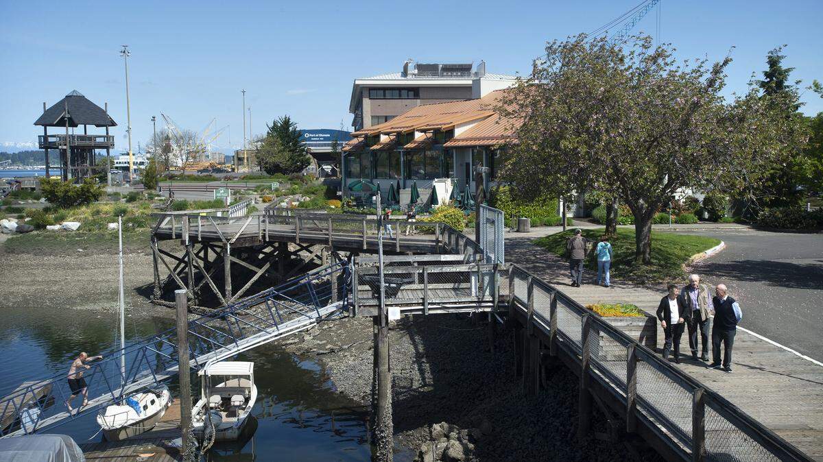 Pedestrians make their way along the Percival Landing boardwalk on Columbia Street near the Port Plaza in 2019.