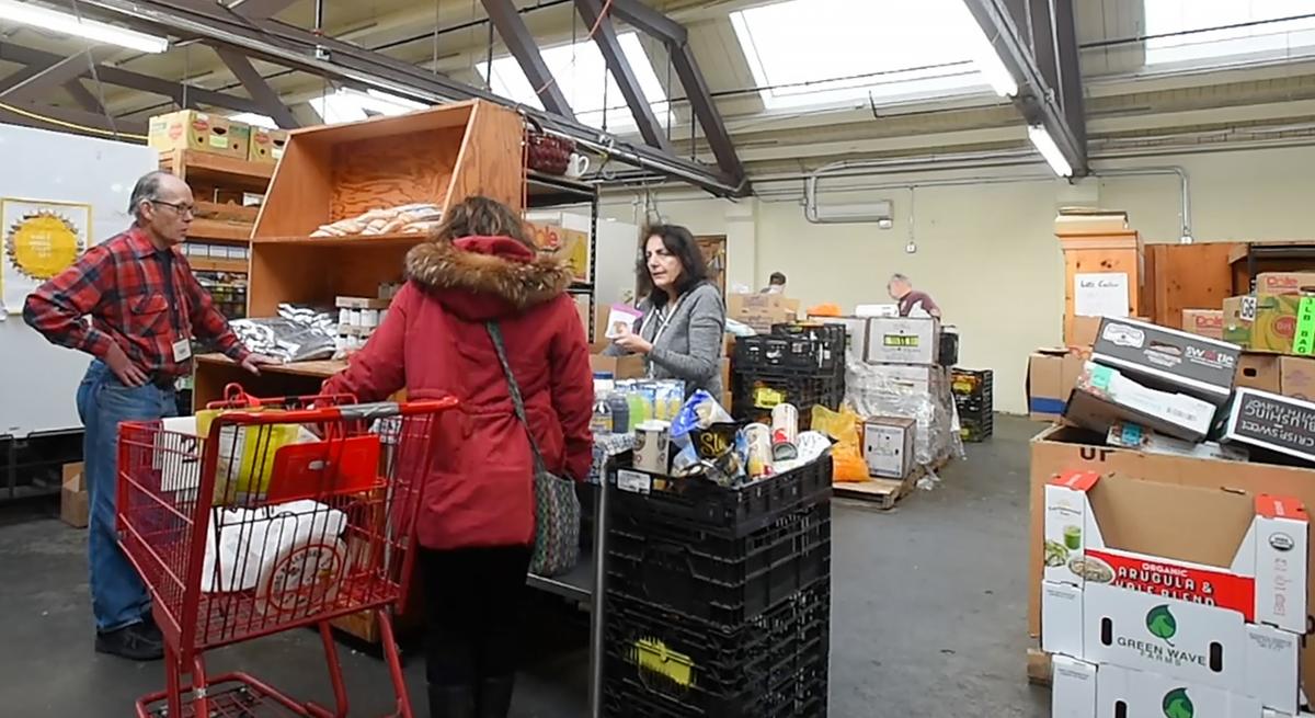 A woman stocks up at the Thurston County Food Bank in downtown Olympia on Wednesday.