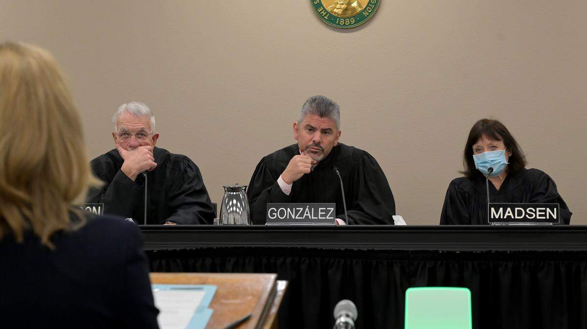 As Washington Supreme Court Chief Justice Steven C. Gonzalez along with Justices Charles Johnson and Barbara Madsen listen as counsel for the respondents Callie Anne Castillo speaks during opening oral arguments in Chris Quinn et al. v. State of Washington et al. on Jan. 26, 2023. The court is expected to return a verdict soon on the case that concerns the capital gains income tax controversy.