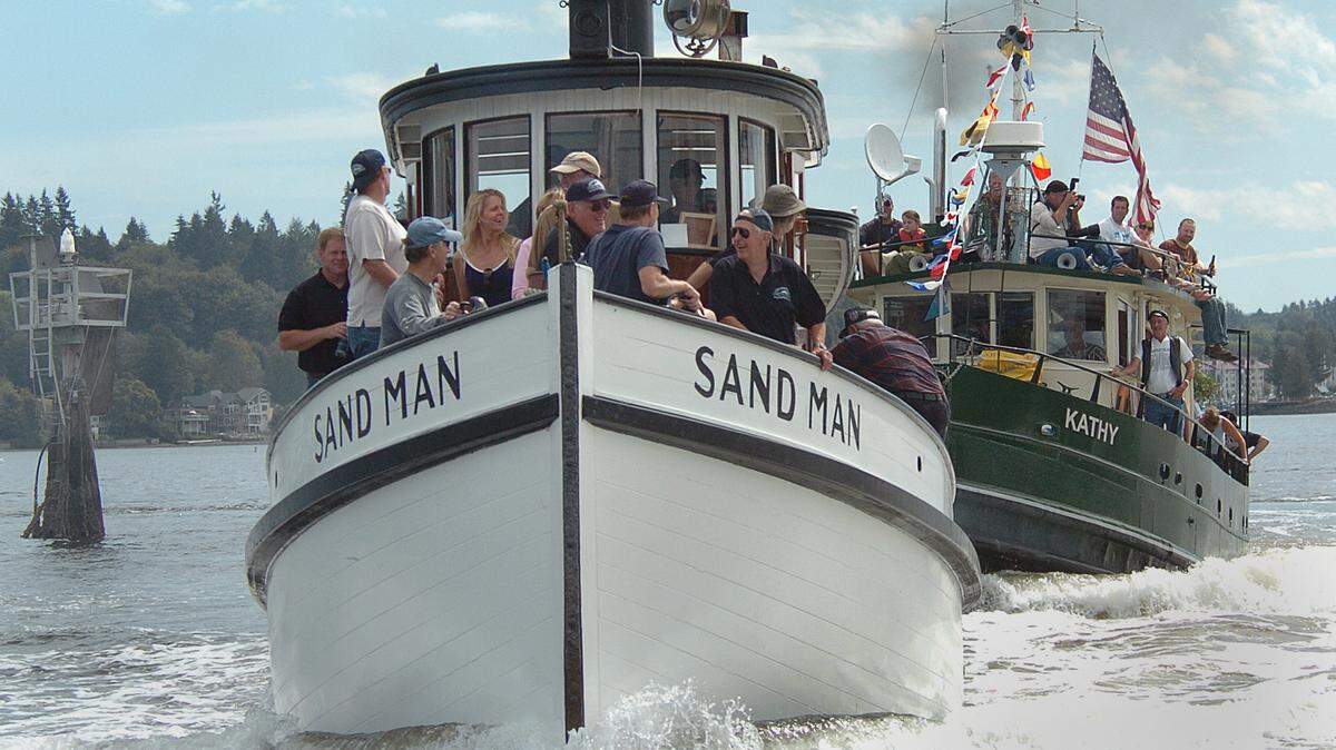 The 97 year-old Sandman holds off the tug Kathy during their race Sunday afternoon. Steve Bloom/The Olympian