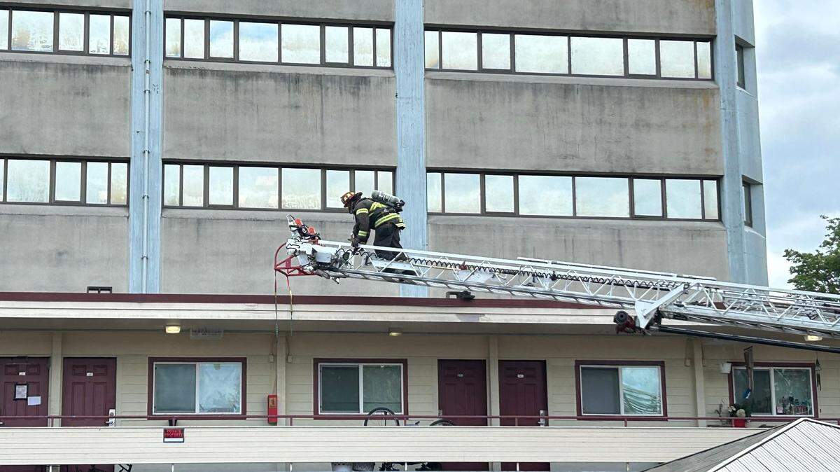 Fireman climbs into second story of building
