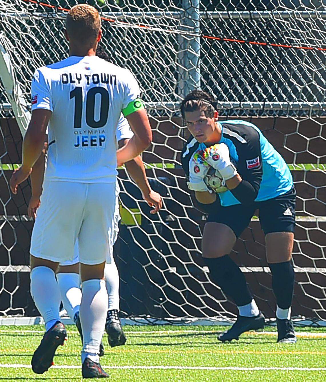 Oly Town Artesians FC goalkeeper Sawyer Price makes a first half stop against OFV Alliance midfielder during their Sunday, June, 26, 2022 at Black Hills High School.