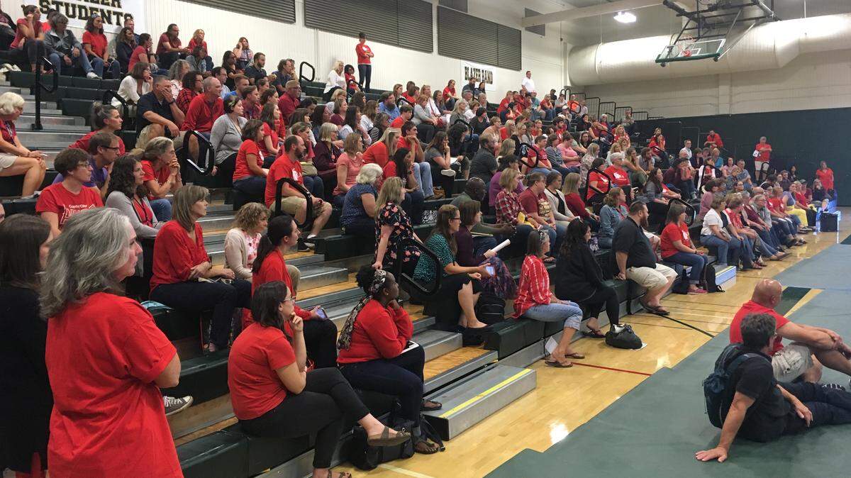 More than half of the members of the North Thurston Education Association gather at Timberline High School in Lacey on Monday to hear the latest on negotiations. The union is asking for double-digit pay increases, which it says the district can afford based on financial projections from the state. The teachers union and district are still negotiating with a week to go before the first day of school.