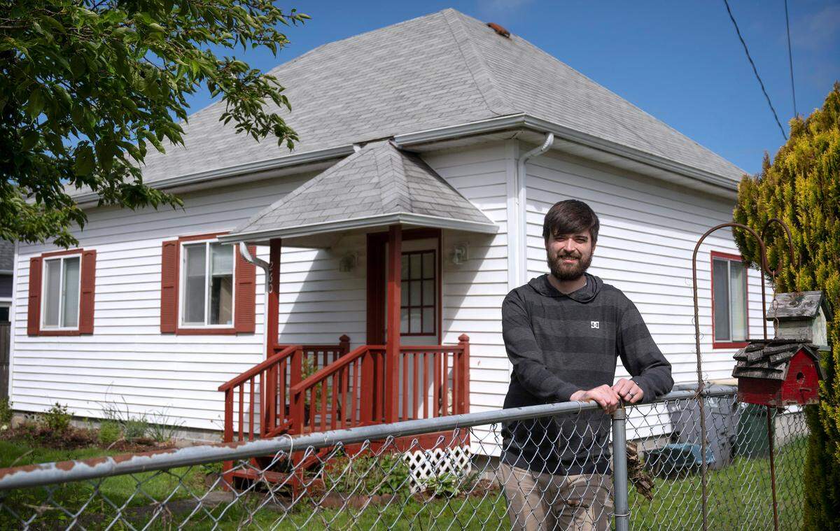 Ashton Burcher outside the rental home he shares with his huband in Tenino, Washington, on Friday, May 20, 2022. A past bankruptcy kept Burcher from getting accepted for other rentals, forcing the couple to live in hotels for nine months before finding a private landlord willing to take a chance. “It’s worked out great,” Burcher said.