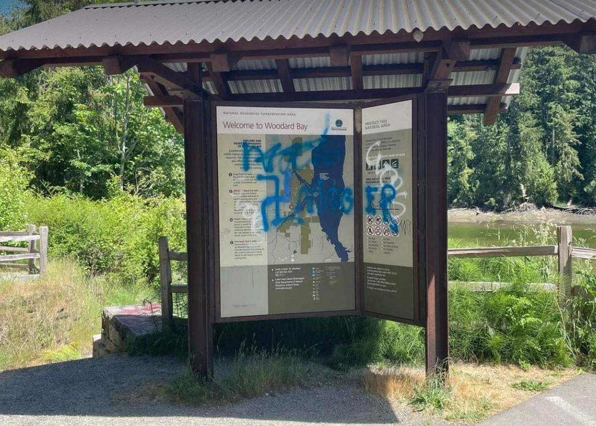 A Nazi swastika and the n-word were found spray painted on a sign at the Woodard Bay conservation area near Henderson Inlet over the weekend.