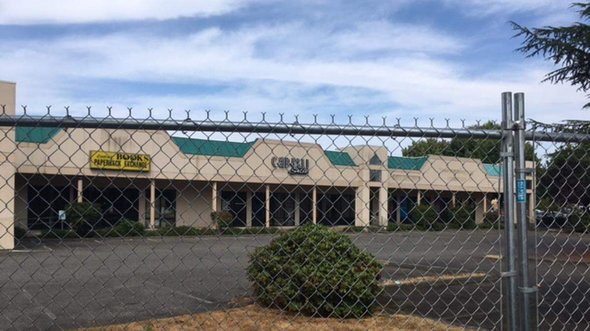 A fence has been erected around an aging retail area in Lacey, suggesting work is about to begin on redeveloping the site into Pacific Station, according to the developer.