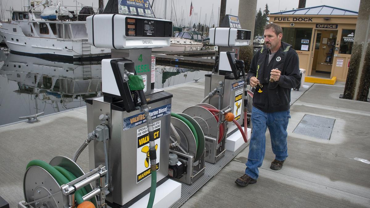 Larry Wirkkala, a Port of Olympia maintenance employee from Rochester, unlocks the pumps as he opens the Swantown Marina Fuel Dock on the downtown Olympia waterfront on Wednesday, Oct. 3, 2018.