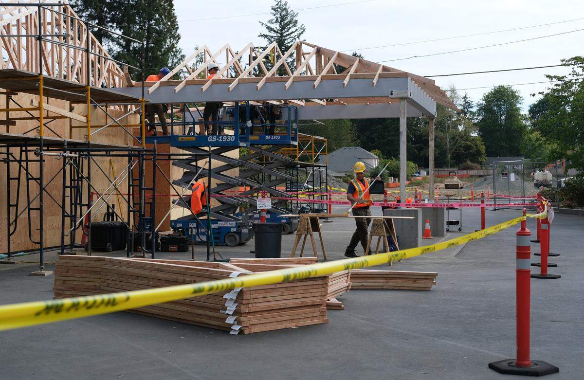 Volunteers work to rebuild the Jehovah’s Witnesses Kingdom Hall in Olympia on Friday, Sept. 23, 2022. Work on the new building started on Aug. 23, 2022, more than four years after an arson fire destroyed the original building.
