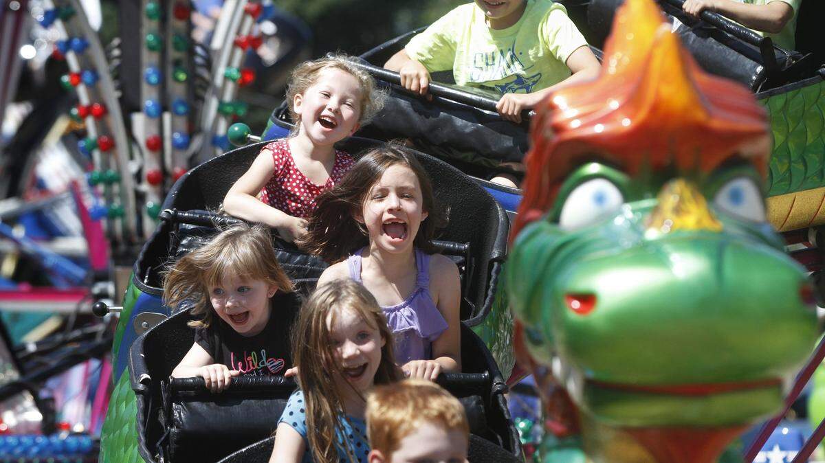 Kids take a wild ride on the Dragon Wagon roller coaster at the 2014 Thurston County Fair in Lacey.