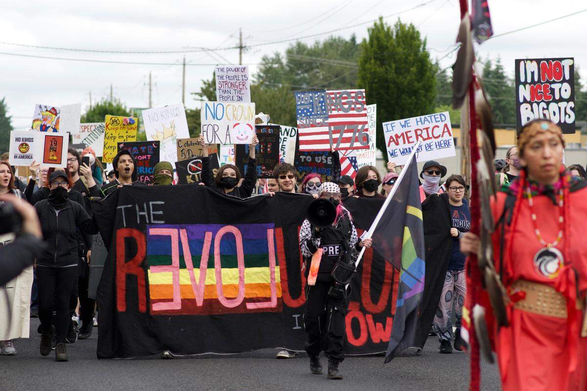 The People’s Rebellion group marched from the Capital Mall in west Olympia to the state Capitol where the group joined the larger “No Kings” protest on Saturday, June 14, 2025, in Olympia, Wash.