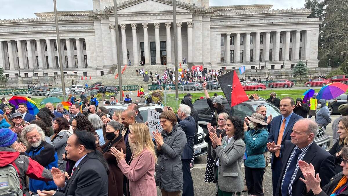 Several state lawmakers joined hundreds of people gathered on the Temple of Justice steps in Olympia Friday, April 21, in support of a Senate Bill on rights for transgender youth passed this week. Opponents of the bill gathered across the way on the Legislative Building steps.