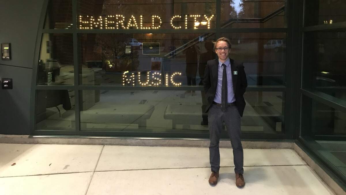 Emerald City Music’s executive director Andrew Goldstein poses outside the Minnaert Center for the Arts at South Puget Sound Community College. The center is now the music series’ home venue.