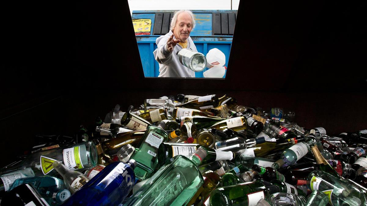 Dennis DeMoor of Lacey drops off a wine bottle for glass recycling at the Thurston County Waste and Recovery Center in Lacey in 2019.
