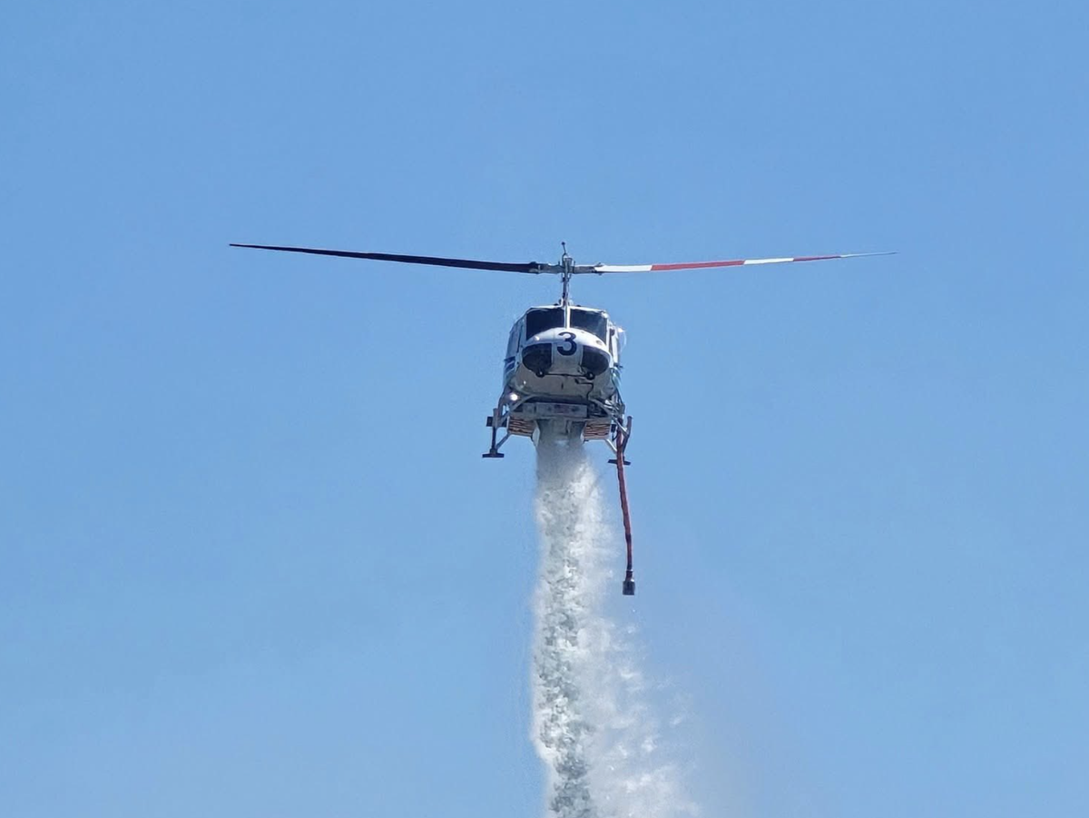 West Thurston Fire Authority shared a photo of a helicopter dropping water over a brush fire near Littlerock on Monday, July 7, 2025.