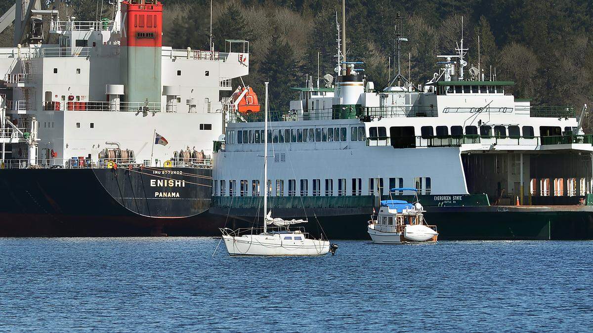 Berthed behind the nearly 600 foot-long cargo ship Enishi, the former Washington state ferry Evergreen State has been moored at the Port of Olympia for more than a year.