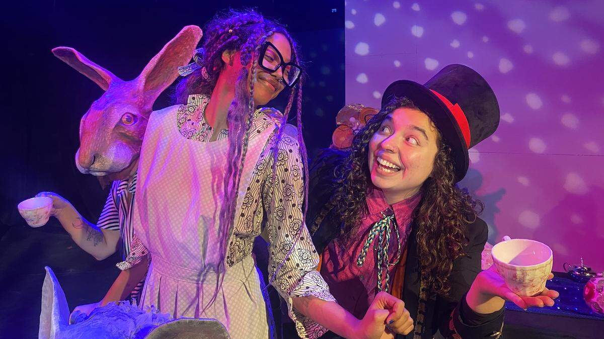 The March Hare (Teal Farías), Alice (Jada Miller) and the Mad Hatter (Lex Langguth-Torres) have a spot of tea in Olympia Family Theater’s world-premiere musical of “Alice in Wonderland.”