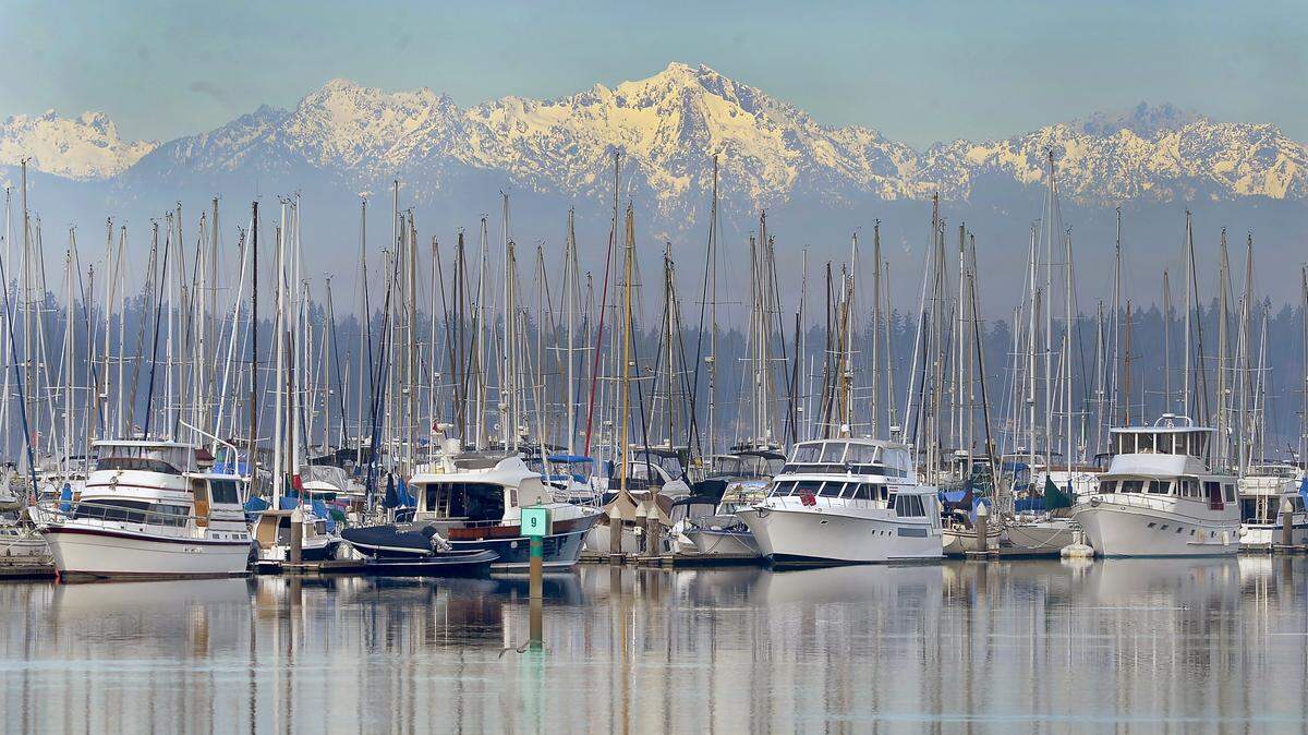 The Olympic Mountains come into view over Olympia’s Swantown Marina. The Port of Olympia commission approved a resolution this week to help two groups potentially affected by the COVID-19 crisis: port tenants and those who live aboard boats at Swantown.