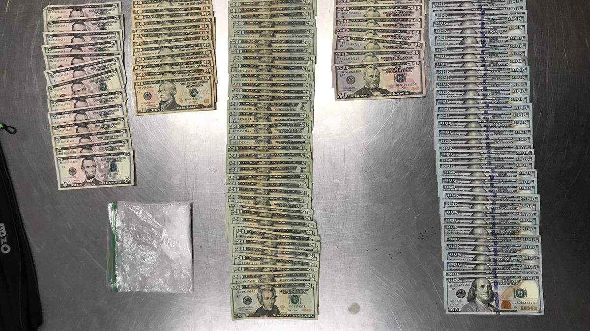 The Olympia police department shared a photo of evidence they collected in a nighttime traffic stop Wednesday, showing $6,515 and 27.6 grams of meth.