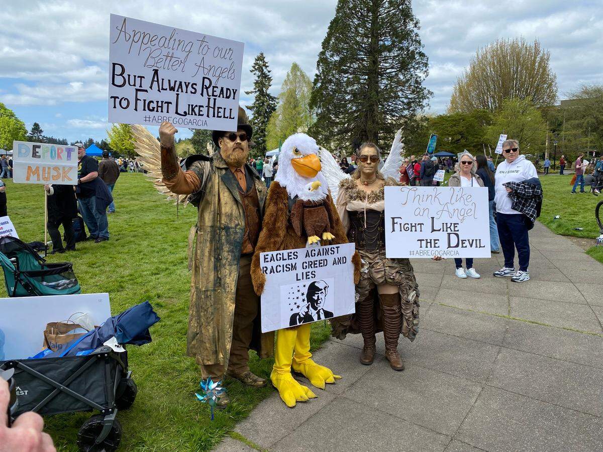 The gold-tinted angels and bald eagle were among the favorite figures for photos on Saturday, April 19, 2025, at the anti-Trump rally at the Capitol Campus in Olympia.