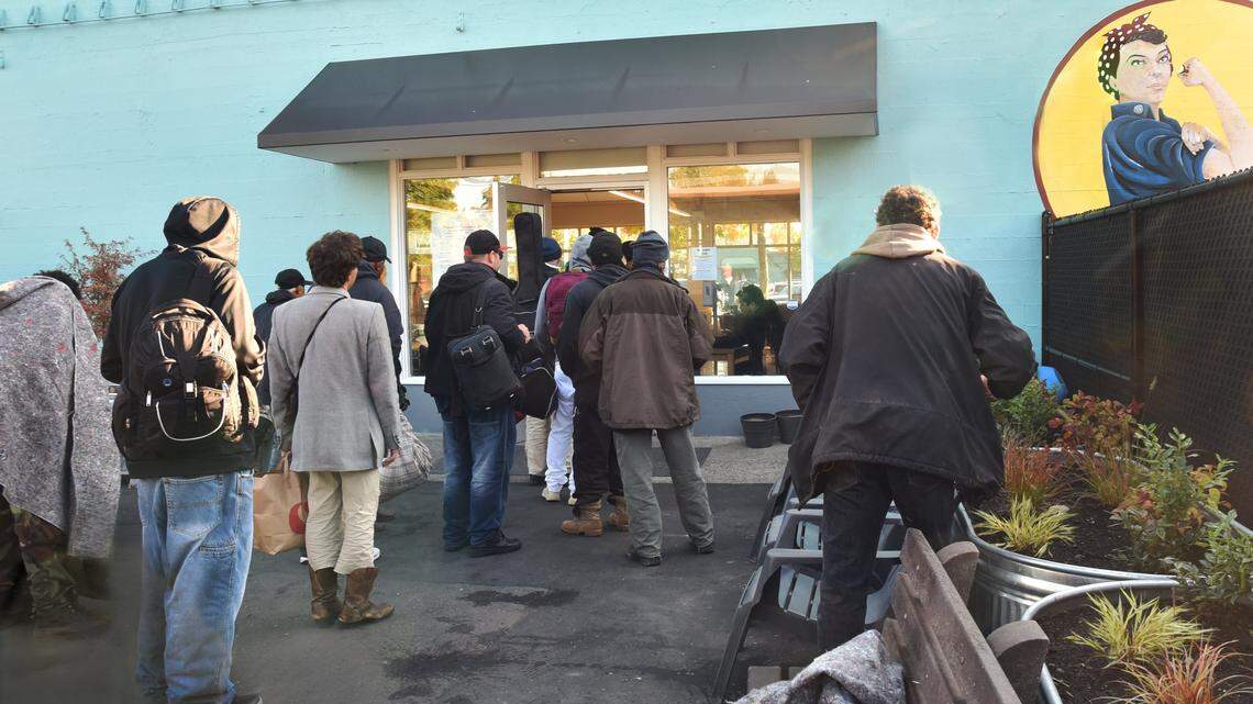 A line of people wait to enter the Providence Community Care Center in downtown Olympia back in October.